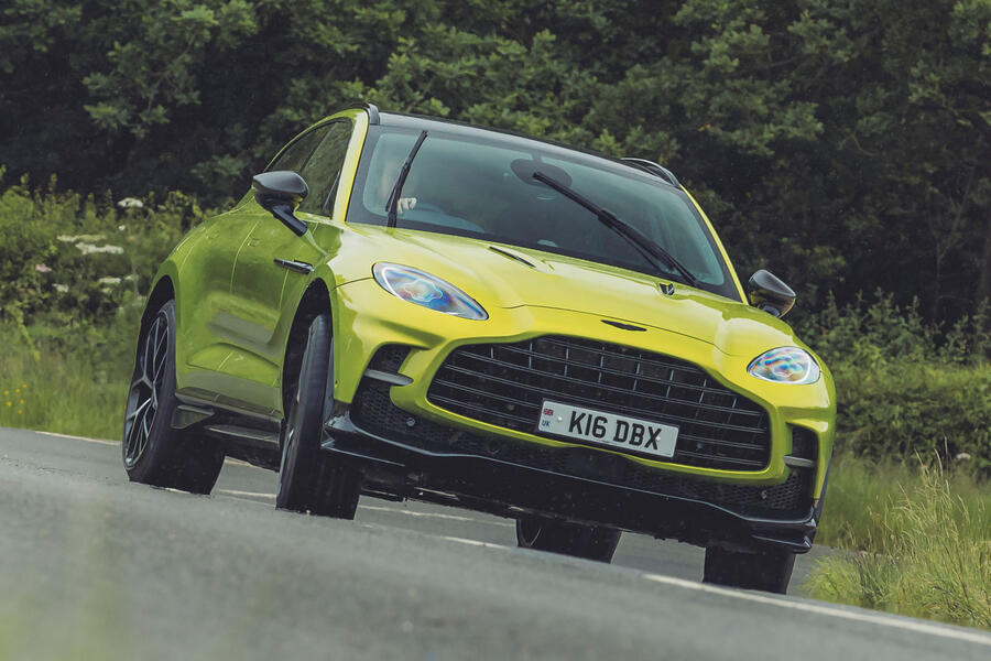 Aston Martin DBX cornering on the road, viewed from the front