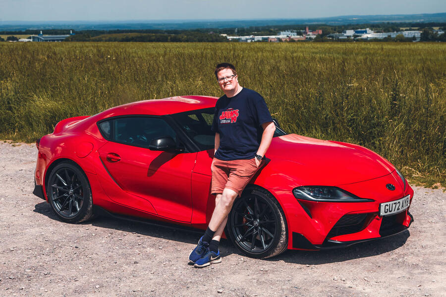 Matt Saunders leaning on a red Toyota GR Supra