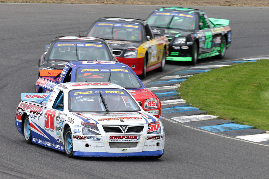 Pick-up racers cornering in a pack