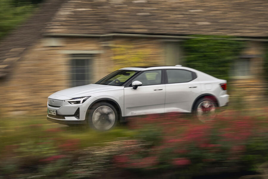 Polestar 2 driving through countryside village â€“ front quarter