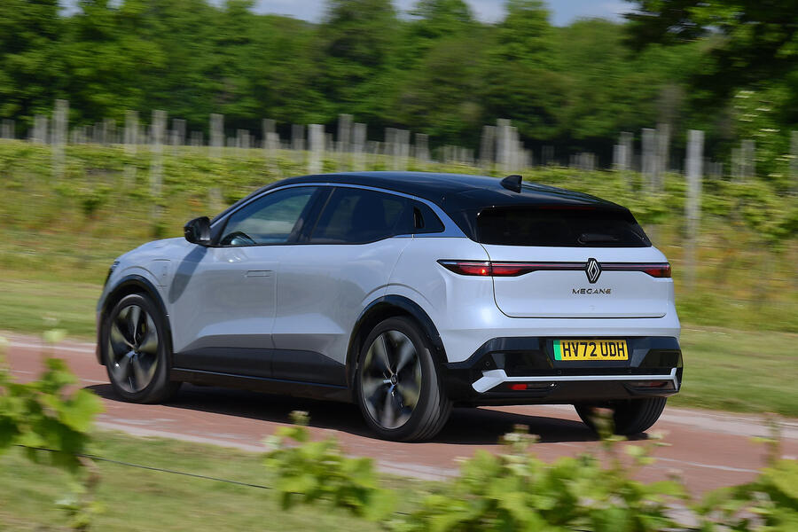 Grey Renault Megane E-Tech driving – rear quarter 