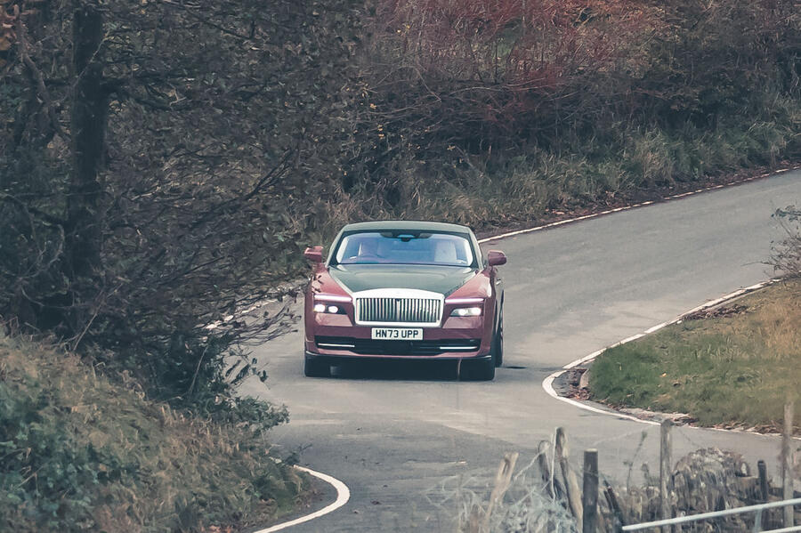 Rolls-Royce Spectre driving through countryside â€“ front