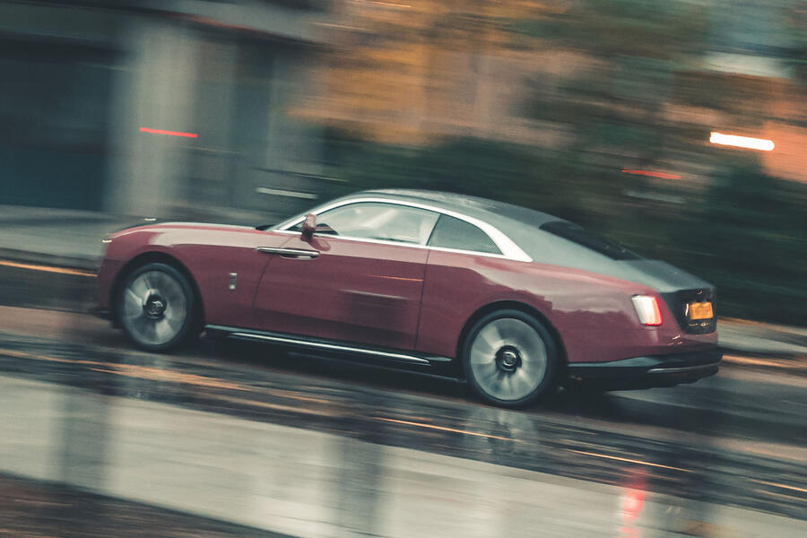 Rolls-Royce Spectre driving through city â€“ rear quarter