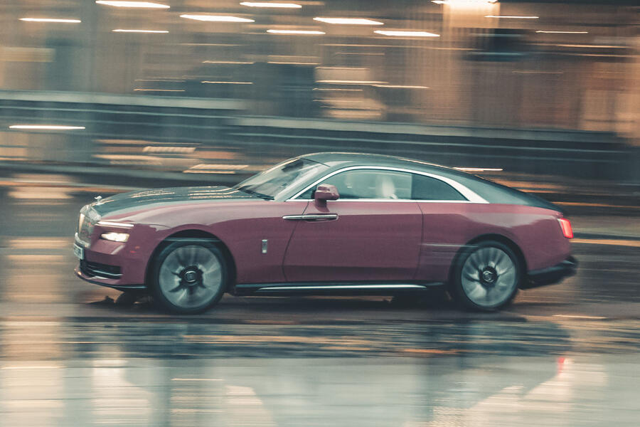 Rolls-Royce Spectre driving through city â€“ side