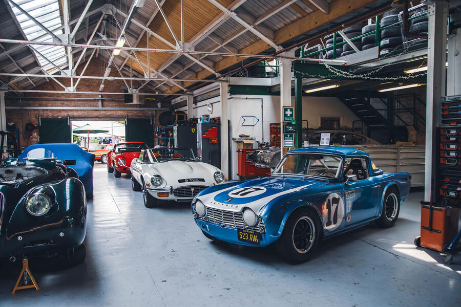 Triumph TR4 parked in Bicester Heritage garage â€“ front quarter